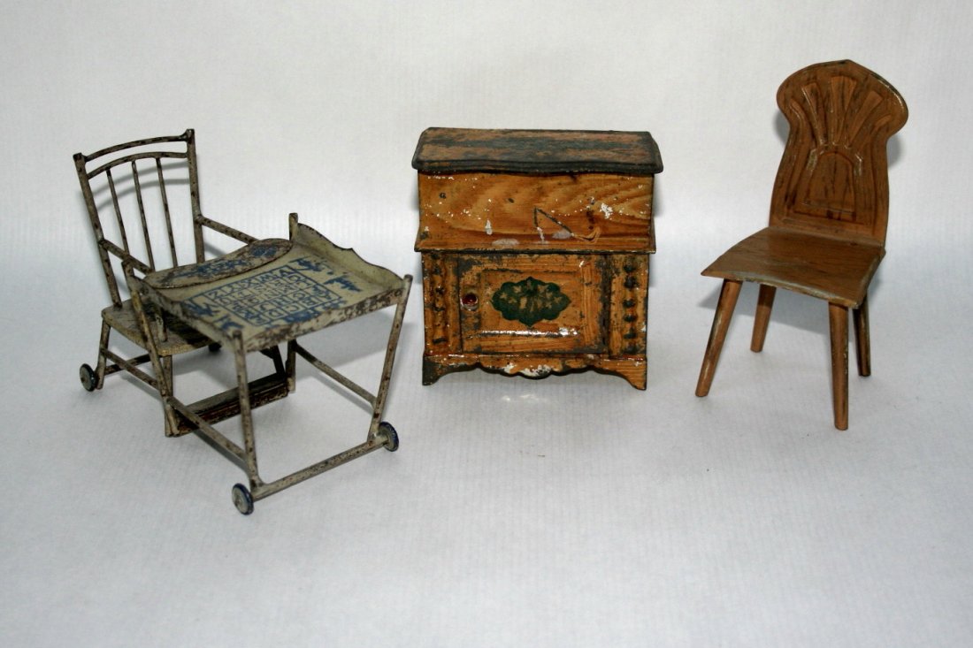 Painted Tin Furniture: A grain-painted washstand by Ellis, Britton & Eaton 3.25" H and W (paint loss and rust), a metamorphic high chair that flips into a wheeled play table and chair with blue decoration, and a painted tin