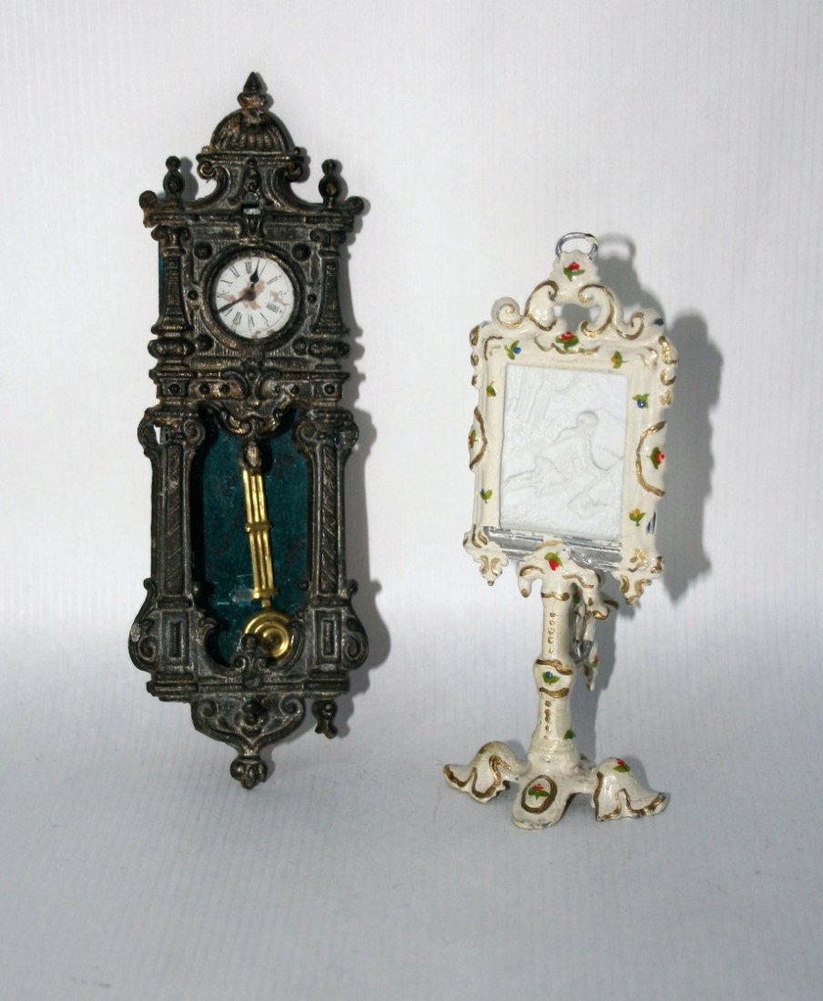 Painted Lithophane and Wall Clock: A larger painted cast metal lithophane with scene of a boy hunting 5" H, some paint loss, and a heavy German cast metal and tin wall clock that has lost its finish and one lower finial. Hands on clock