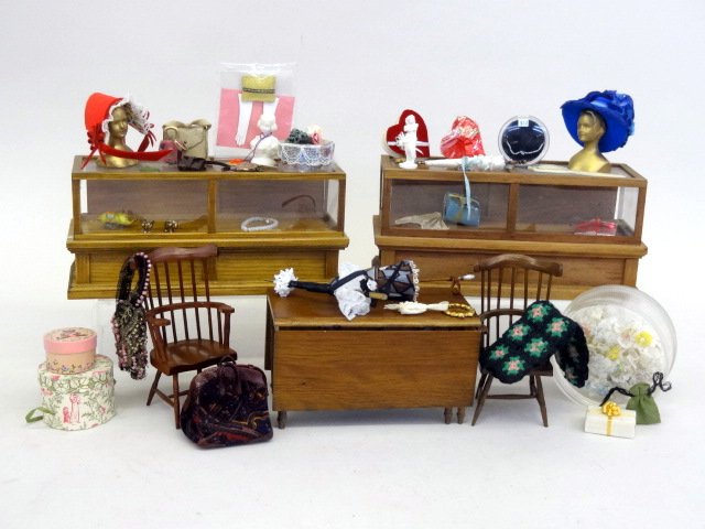 Lady's Millinery Furnishings: Display cases filled with purses, trinkets, gift boxes, jewelry, etc., a table and chairs by handcraft Designs and assorted hatboxes and luggage, hats, etc. Crocheted afghan 2.5" X 4".