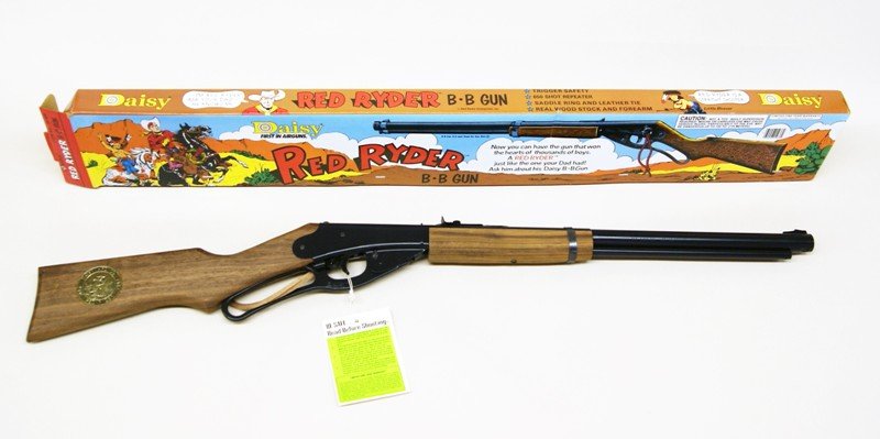 Daisy Red Ryder BB Rifle in O/B: Daisy Red Ryder BB rifle in original box. Has real wood stock & forearm, saddle ring & leather tie, 650 shot repeater, trigger safety