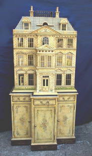 Maitland Smith Baby House: An impressive dollhouse with its own matching cabinet, made by Maitland-Smith. The exterior has been finished to look like aged limestone and the back Is left open to display a rabbit's warren of smal