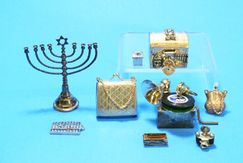 Group Silver Miniatures: Pirate's chest w/lock 1 in. (W), menorah 2.2 in. (H), abacus signed illegibly, purse w/bright cut decoration 1.1 (w), marked .925, small purse marked .925, camera, lidded box, open box & silver plate