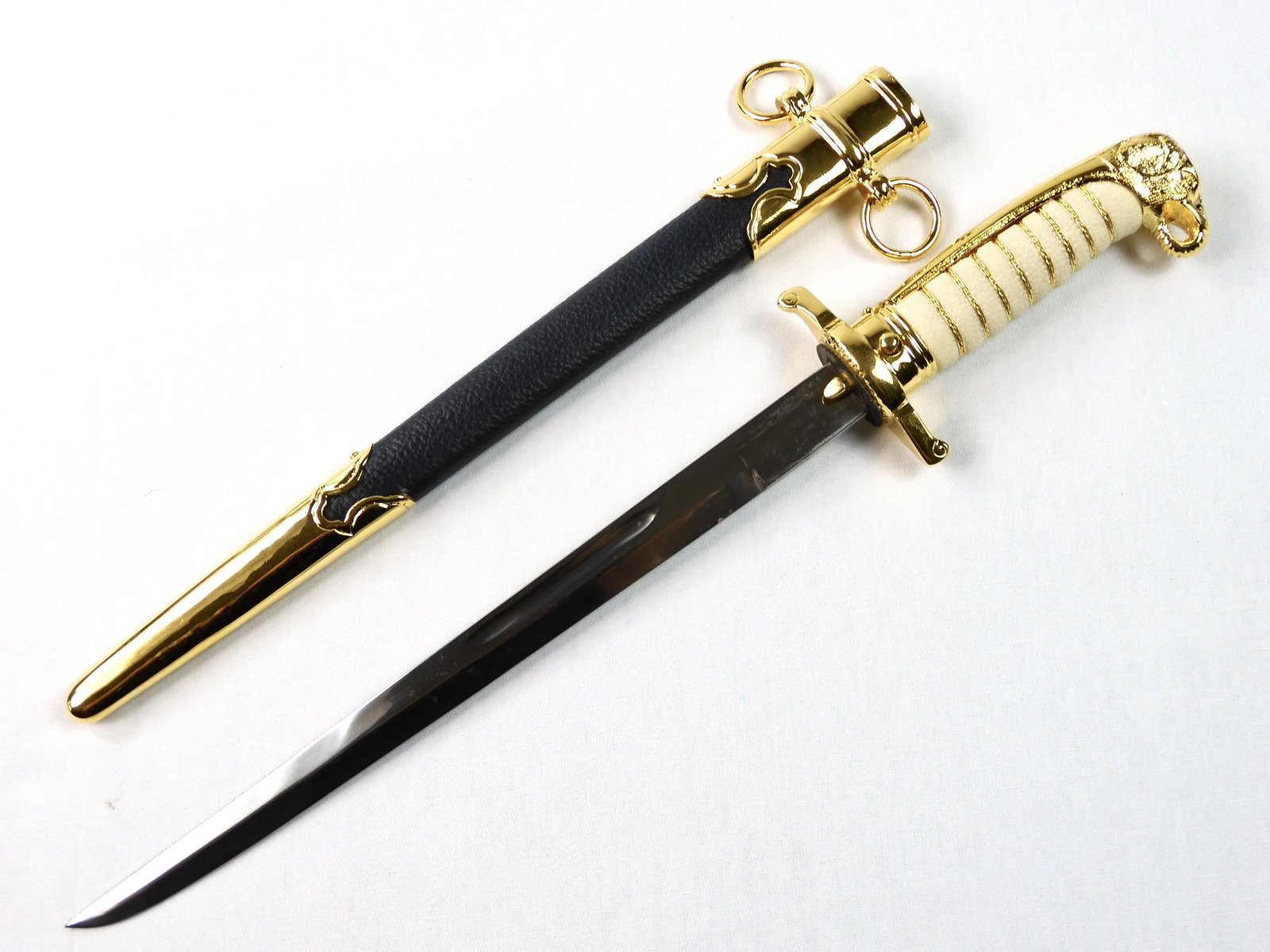 Thai Royal Air Force Cadet's Elephant Head Dagger Knife: Thai Royal Air Force Cadet's Dagger with Scabbard. Elephant head pommel. The dark blue scabbard's leather differs it from the black Navy Cadet's dagger. 14 1/2" long with 10 1/8" blade. Solid, no loos