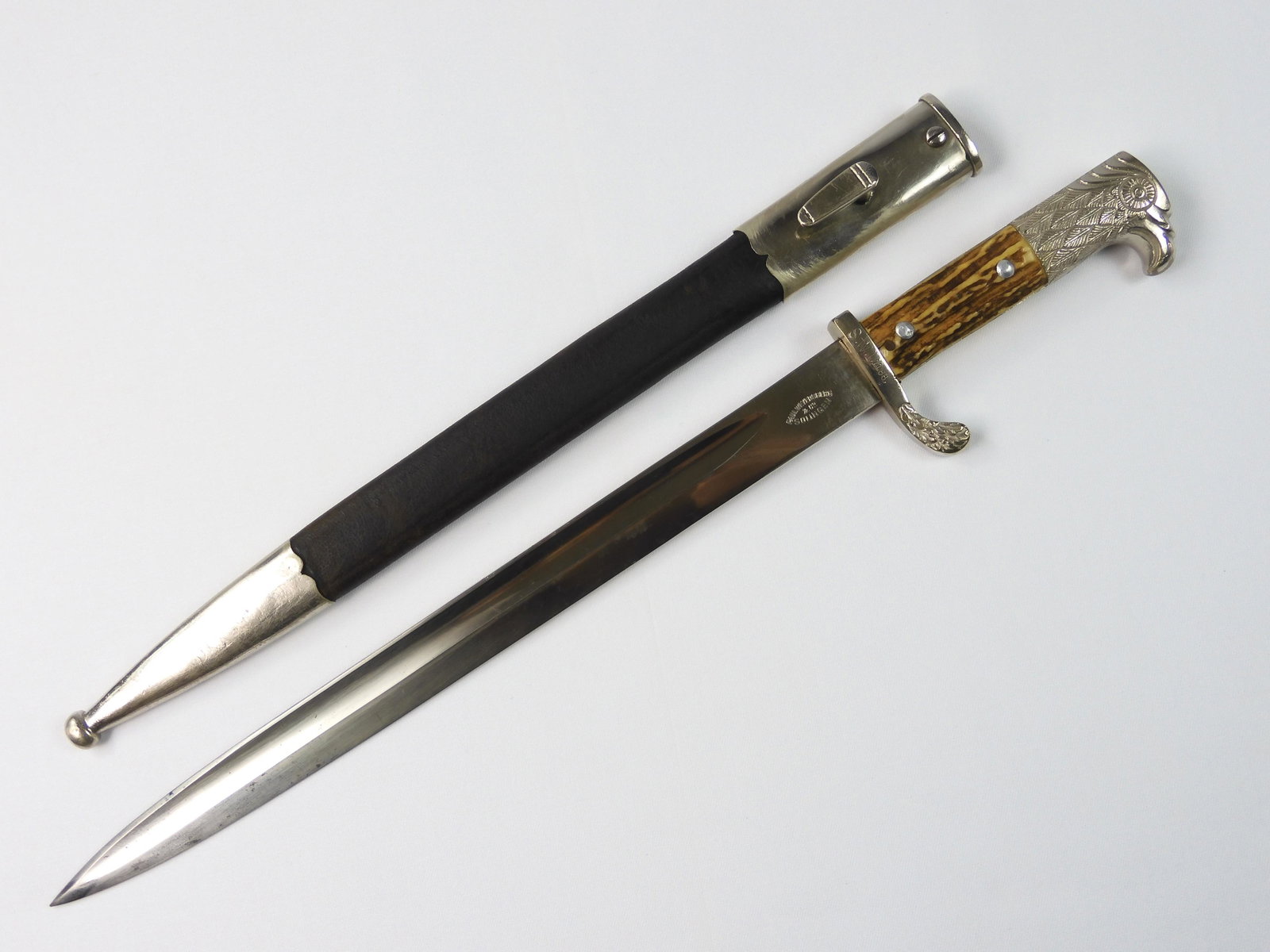 German Nazi WW2 Eagle Head Police Bayonet Knife: German Nazi WW2 Paul Weyersberg & Co. Solingen Eagle Head Police Bayonet with Scabbard. Excellent condition. Solid. 17 1/2" long with 13" blade. Matching "S.W.I. 1188" on the blade and scabbard indica