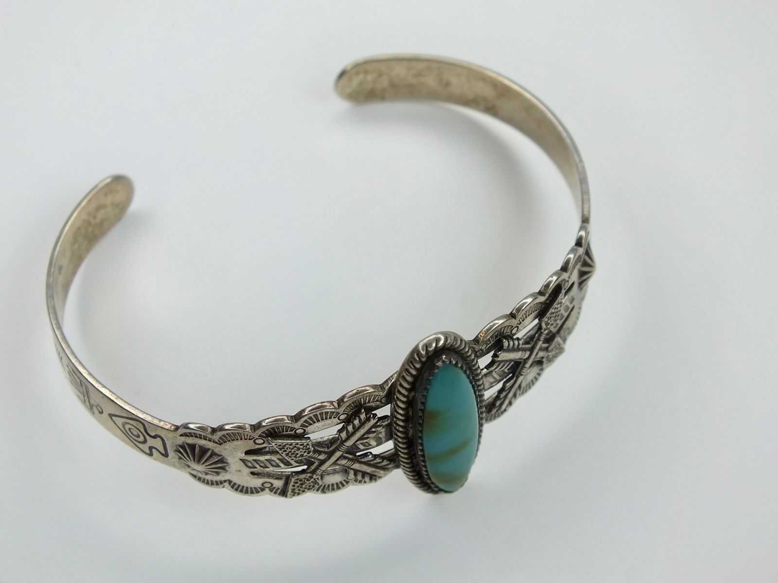 Fred Harvey Era Sterling Silver Green Turquoise Native American Cuff Bracelet with arrows: Fred Harvey Era Sterling Silver Green Turquoise Native American Cuff Bracelet with arrows. Bracelet marked. Inner circumference 5 inches, opening (gap) 1 inch.
