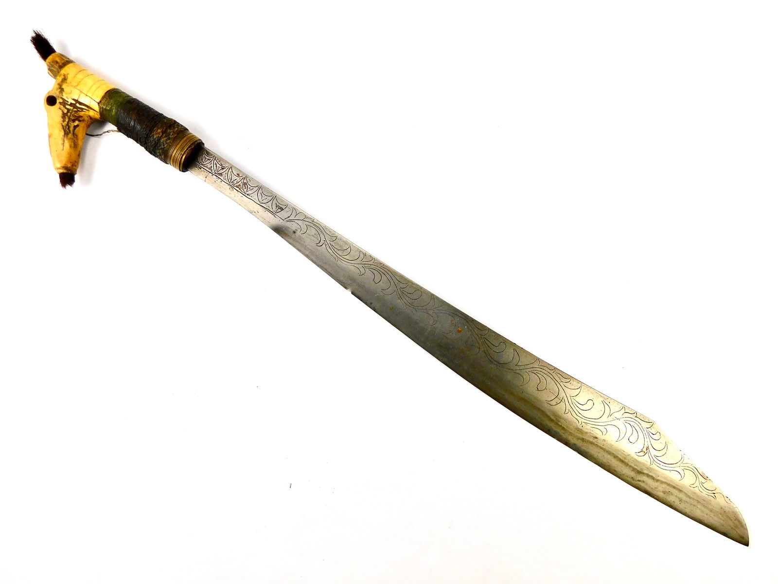Antique Borneo Dayak Headhunters Mandau Engraved Sword: Antique Borneo Dayak Headhunters Mandau Sword. No scabbard. Solid, no loose parts. Ox bone handle. 24" total length. The blade is 19 1/2". No international shipping for this item.
