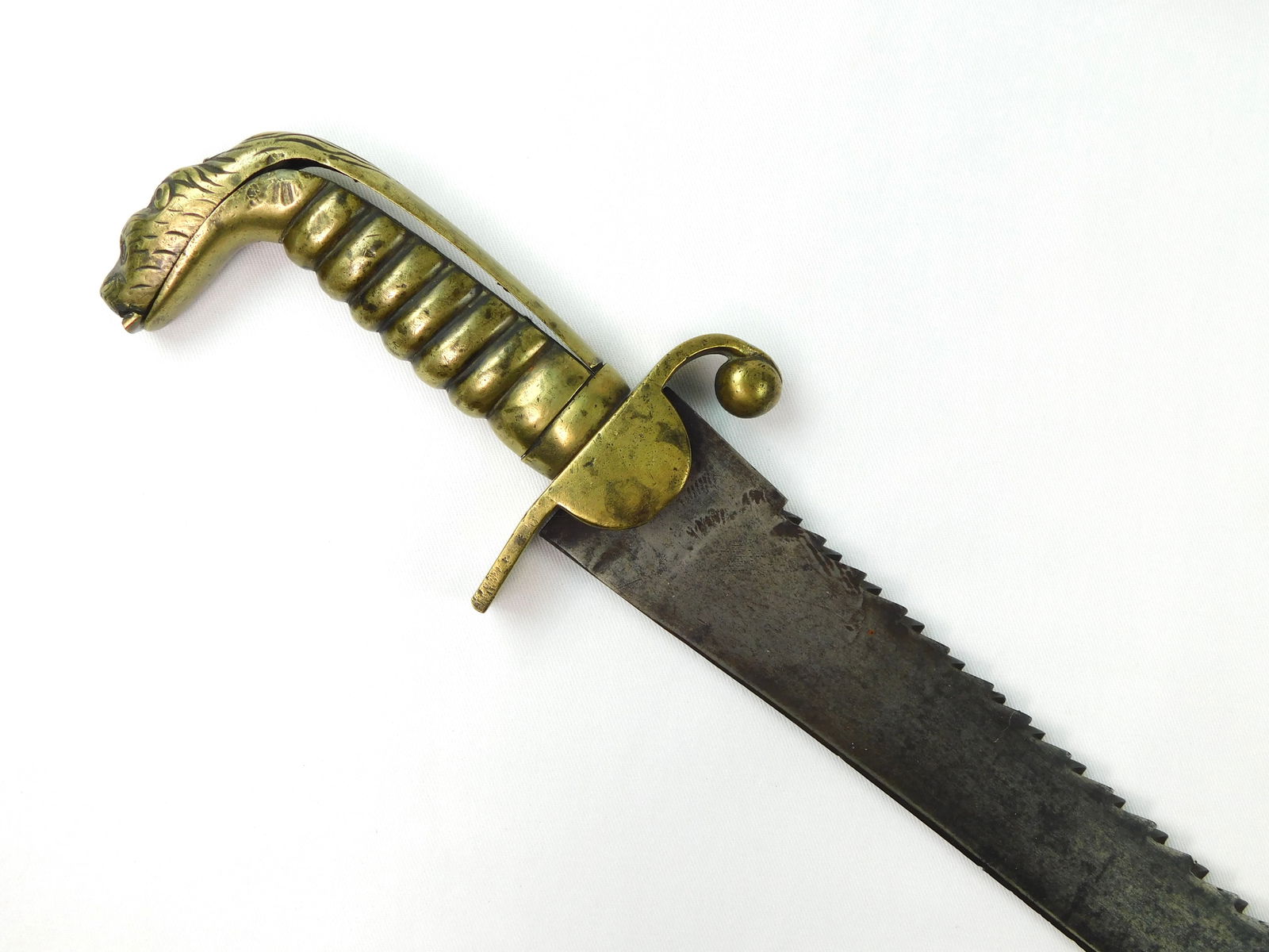 British English Antique M 1831 Saw Back Lion Head Sword: British 19 Century Model 1831 Saw Back Lion Head Short Sword. No scabbard. Handle parts are little loose. 26 5/8" total length. Blade is 22".