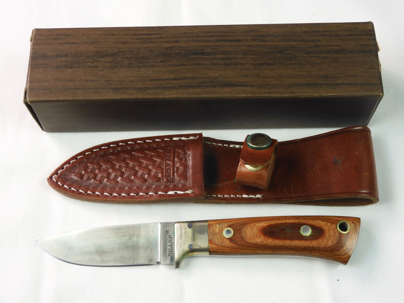 Vintage Japan Made Sharp M 1000S Hunting Bowie Knife: Vintage Japan Made Sharp Model 1000S Hunting Knife with Leather Sheath and Box. Solid, no loose parts. 8" total length. The blade is 3 1/2".LiveAuctioneers is currently displaying only it's own expens