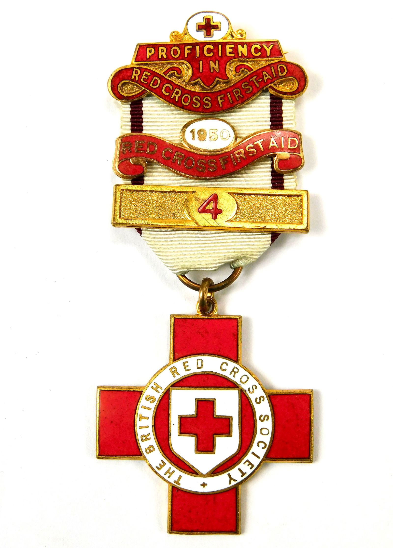 British Red Cross Society Proficiency in First Aid Medal 1950 Named: In-House Shipping. Original British Red Cross Society Proficiency in Red Cross First Aid medal, dated 1950, complete with enameled cross and decorative top bar. The medal is mounted on its original wh