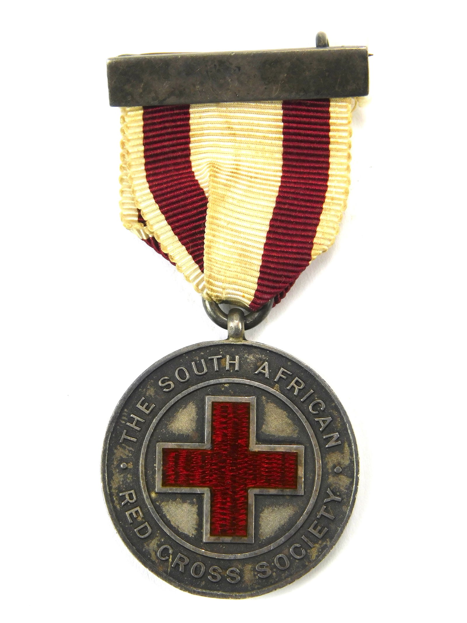 South African Red Cross Society Proficiency Medallion Officially Awarded & Engraved: In-House Shipping. South African Red Cross Society Proficiency Medallion, officially awarded and engraved to R. Mitchell. This is an early silver issue, suspended from the original red-and-white ribbo