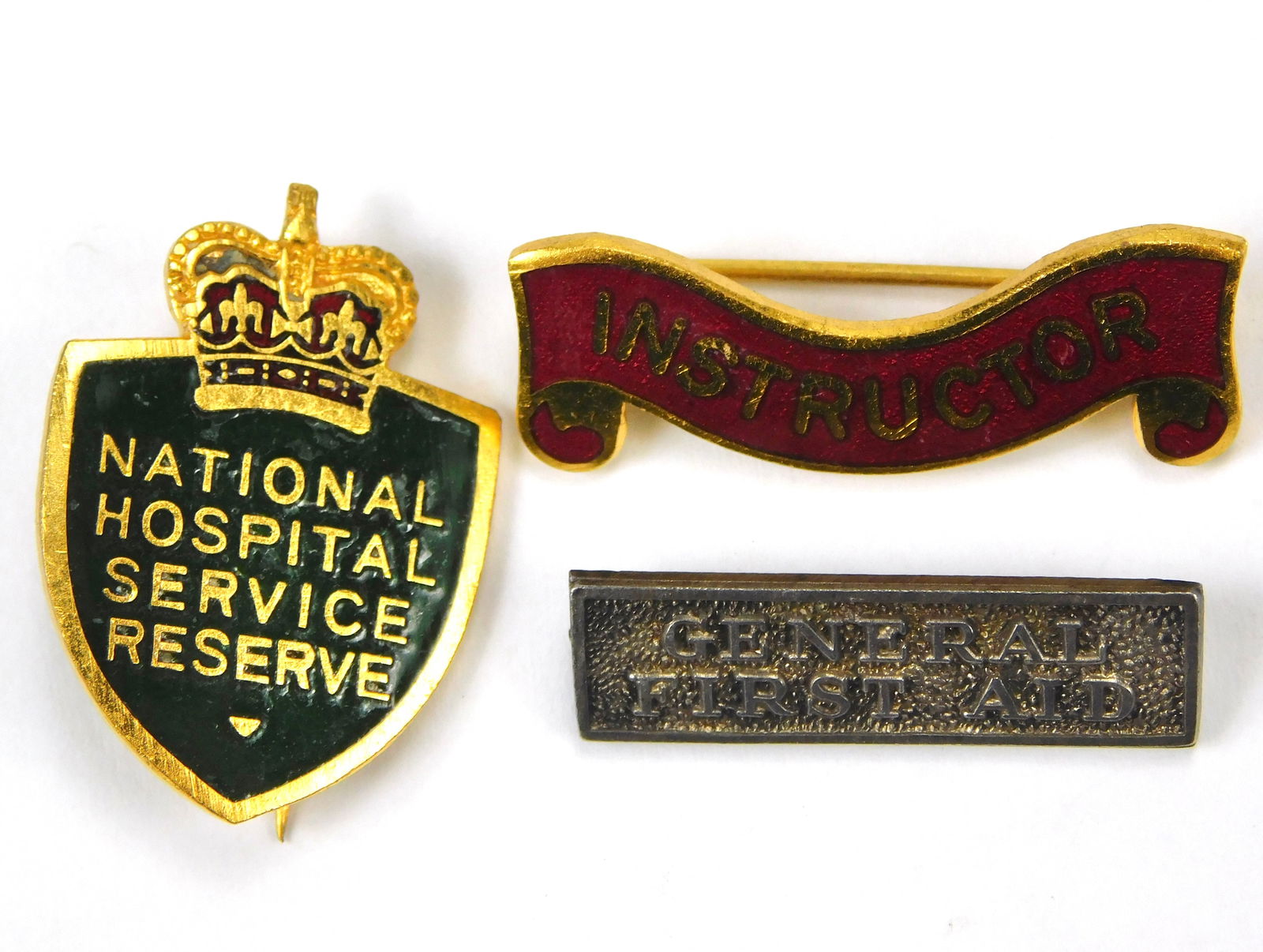 British Red Cross Civil Defence Instructor Service Badge Lot of 3 AR Gaunt London: In-House Shipping. British Red Cross and Civil Defence group including National Hospital Service Reserve enamel badge marked AR GAUNT LONDON, Red Cross Instructor bar marked AR GAUNT LONDON, and Gener