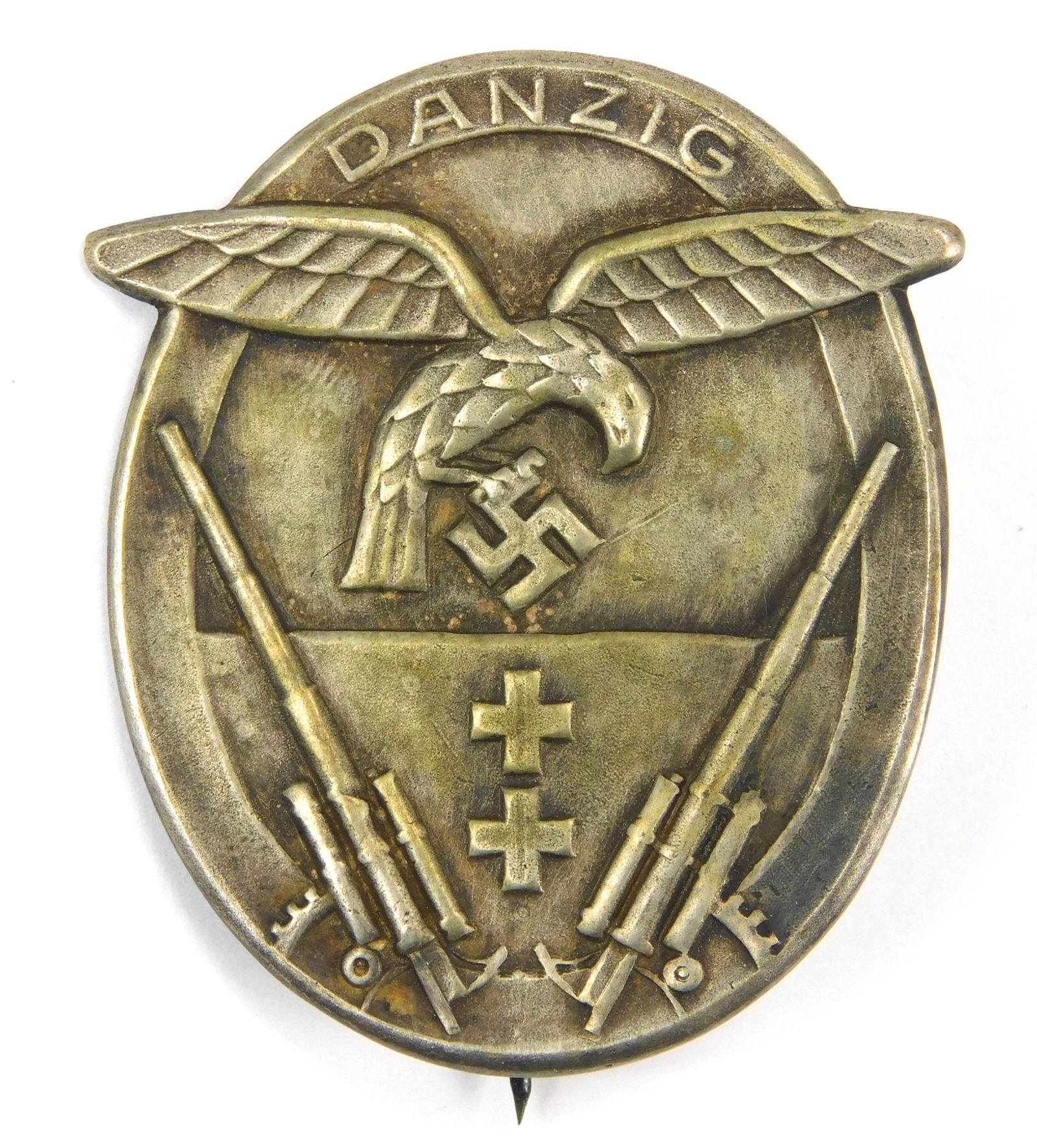 German WW2 Danzig Shield Badge Stuhlweiss Danzig Maker Marked Eagle Swastika Rifles: In-House Shipping. German WW2 Danzig Shield badge, maker marked STUHLWEISS & SOHN DANZIG on the reverse. Oval zinc/white metal construction with high relief details showing a spread-wing eagle clutchi