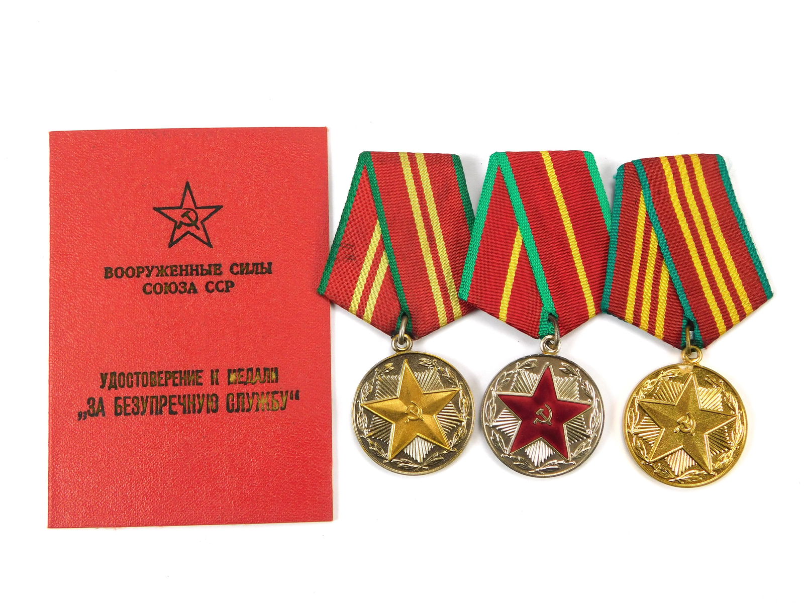 Lot of 3 Soviet Armed Forces Long Service Medals w/ Award Booklet: In-House Shipping. Set of three original Soviet Armed Forces long-service medals, including 10-Year, 15-Year, and 20-Year service awards. Each medal features the five-point star design with service ri