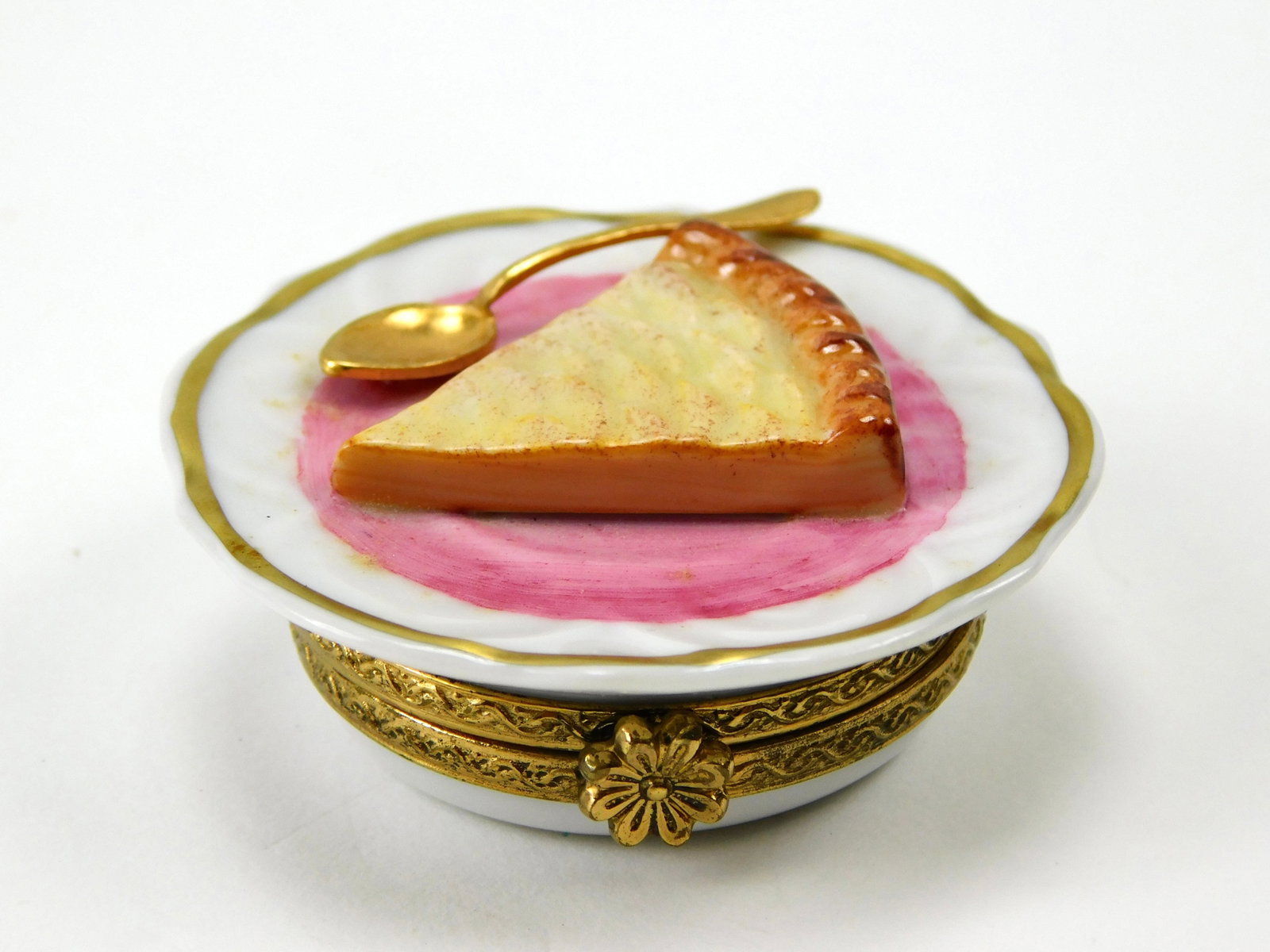 Art de Limoges Pierre Custard Pie Slice Dessert Porcelain Trinket Box: In House Shipping. Art de Limoges Pierre porcelain trinket box modeled as a slice of custard-style pie served on a dessert plate. The dimensional pie features a golden-brown crimped crust, light cream