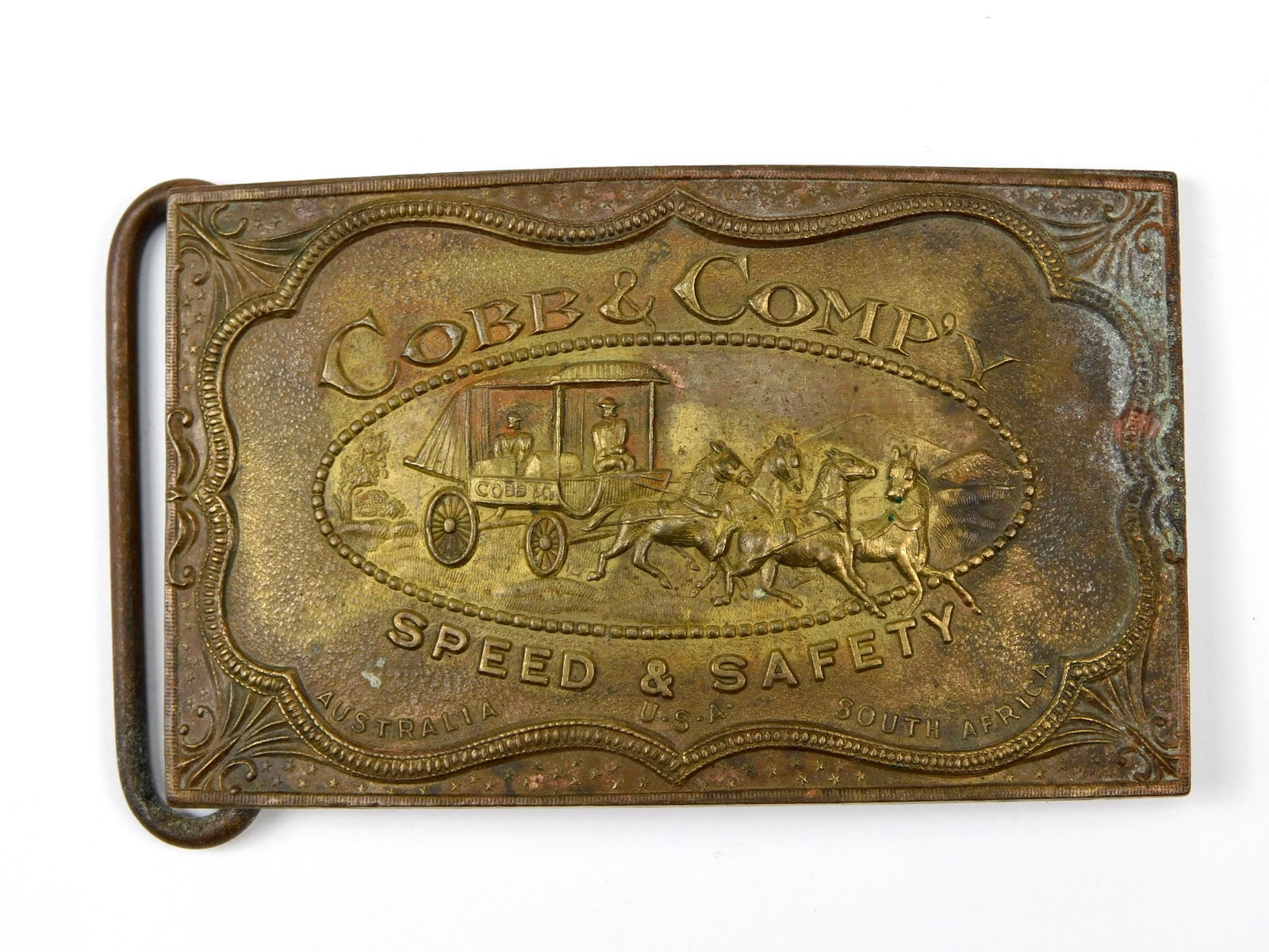 Cobb & Co Speed & Safety Stagecoach Belt Buckle Tiffany Fantasy Brass Replica: 1970s Cobb & Co. “Speed & Safety” fantasy belt buckle, associated with the well-known John R. Fairchild series of reproduction/fantasy buckles produced during the late 1960s and early 1970