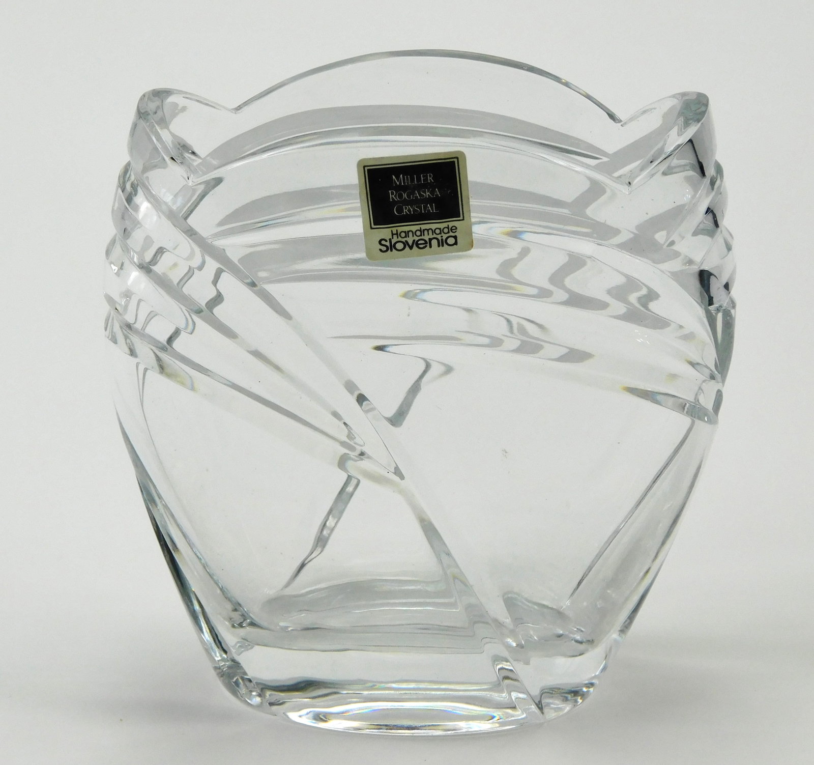 Miller Rogaska Crystal Vase Handmade Slovenia Swirl Cut Art Glass 4.5": In House Shipping. Miller Rogaska crystal vase handmade in Slovenia, featuring a substantial clear crystal construction with a sculptural form, sweeping swirl-cut design and wavy rim. Measures approxi