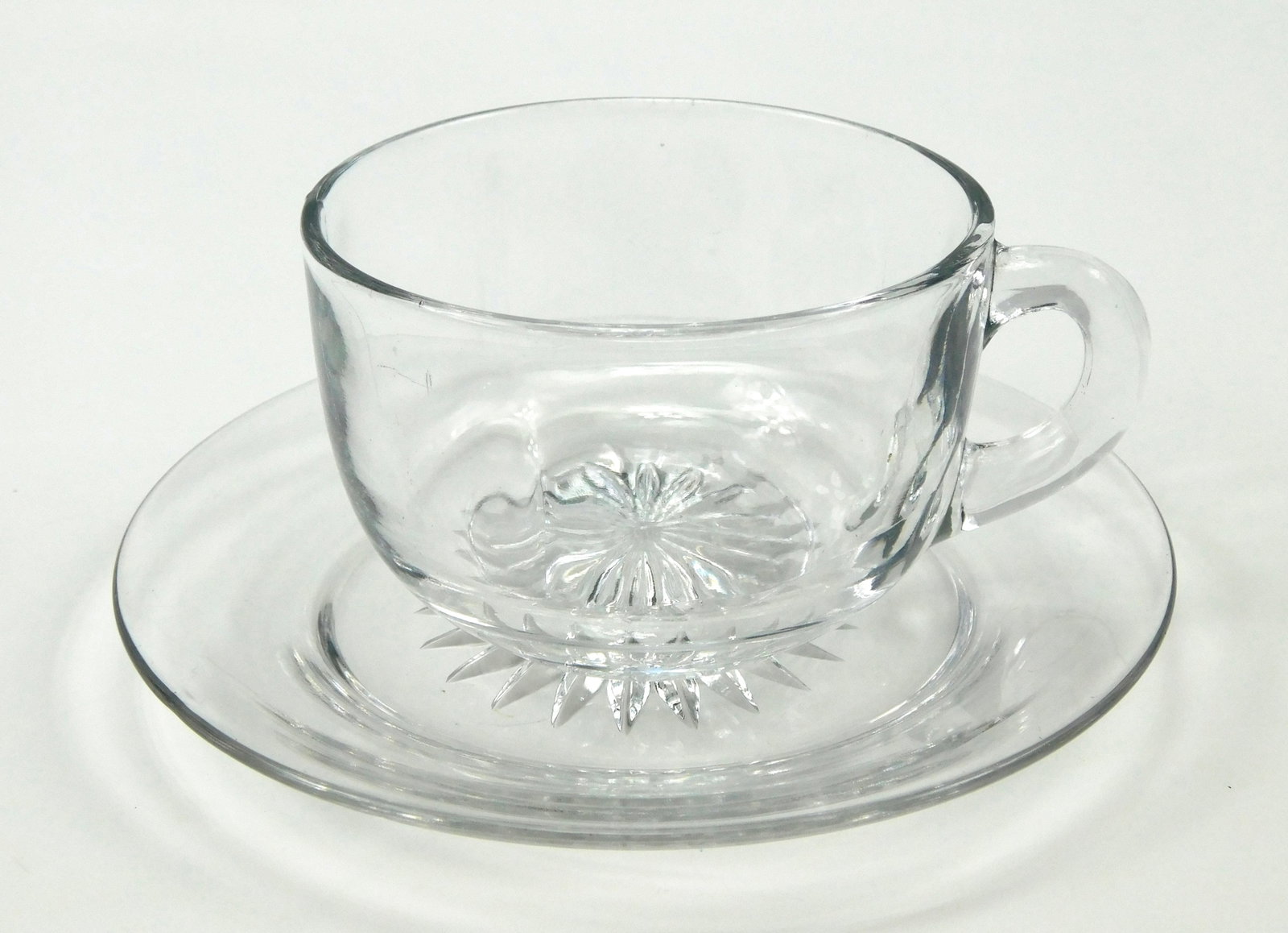 Vintage Heisey Clear Glass Cup & Saucer Set Diamond H Mark Starburst: In House Shipping. Vintage clear glass cup and matching saucer set by A.H. Heisey & Company. Both pieces feature a pressed starburst design on the underside and bear the raised H inside a diamond Heis