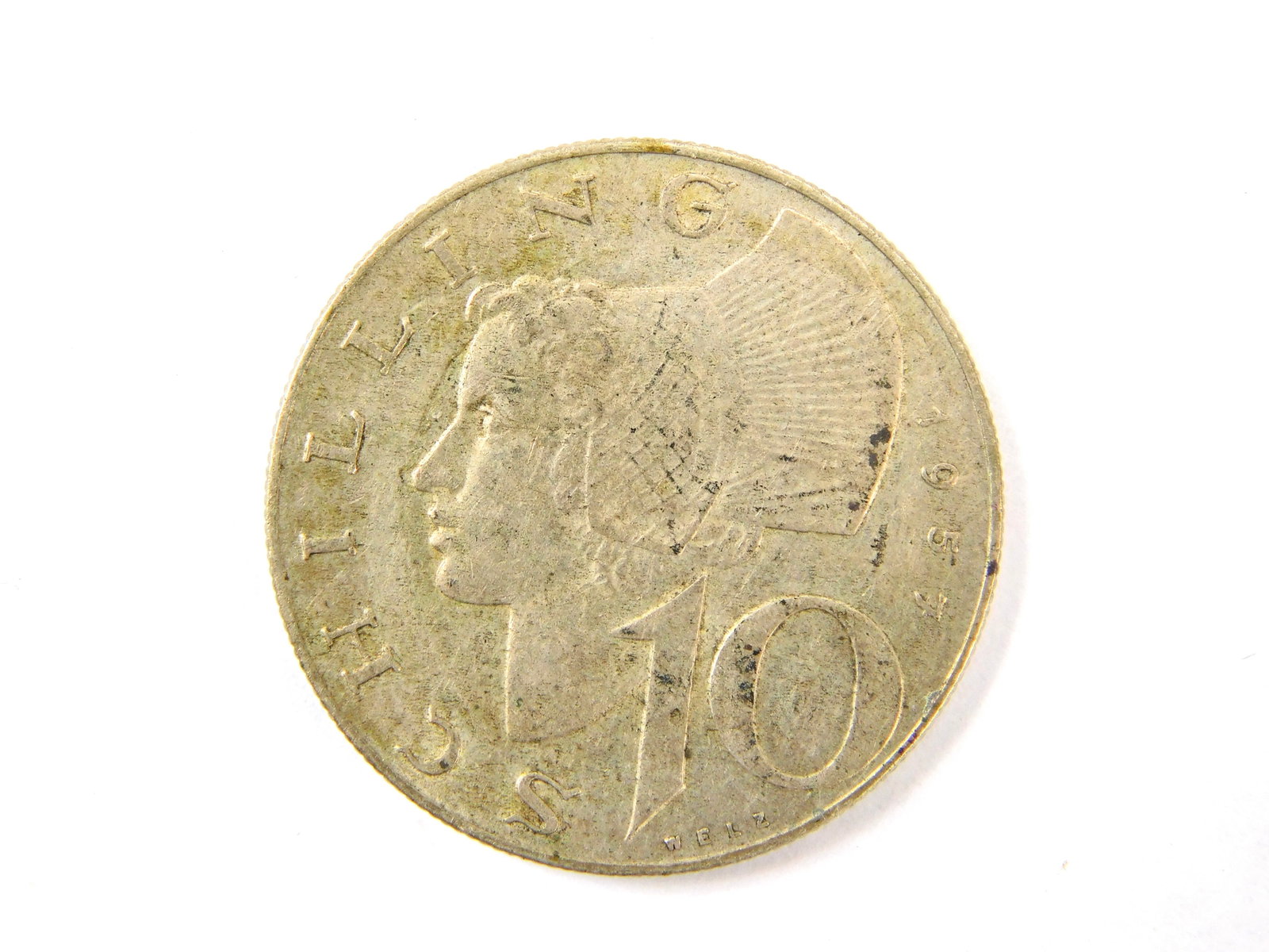 1957 Austria 10 Schilling Silver Coin KM# 2882: In House Shipping. 1957 Austria 10 Schilling silver coin, KM# 2882. Obverse features the Austrian shield surrounded by REPUBLIK ÖSTERREICH. Reverse features a left-facing woman wearing traditiona