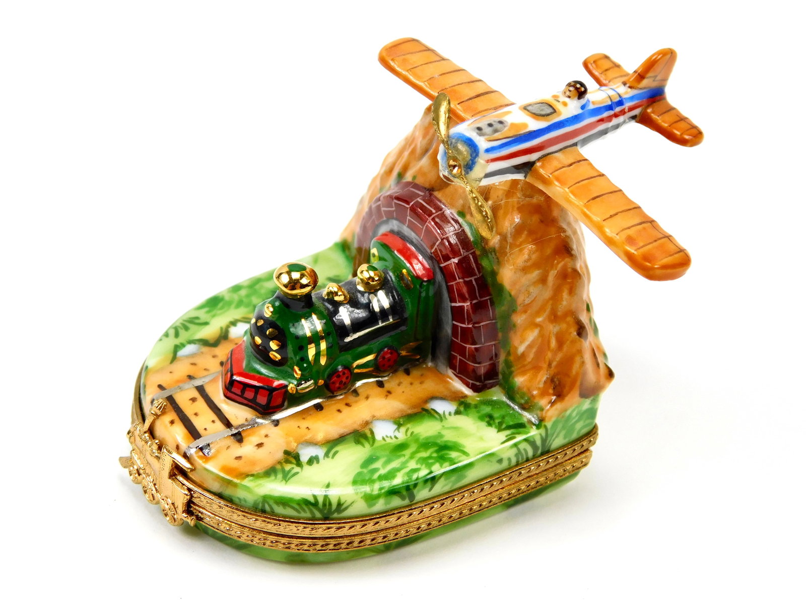 Limoges France LT Peint Main Steam Train Tunnel Airplane Porcelain Trinket Box: In House Shipping. Limoges France hand-painted porcelain figural trinket box depicting a steam locomotive emerging from a mountain tunnel with a propeller airplane flying above. Features colorful land