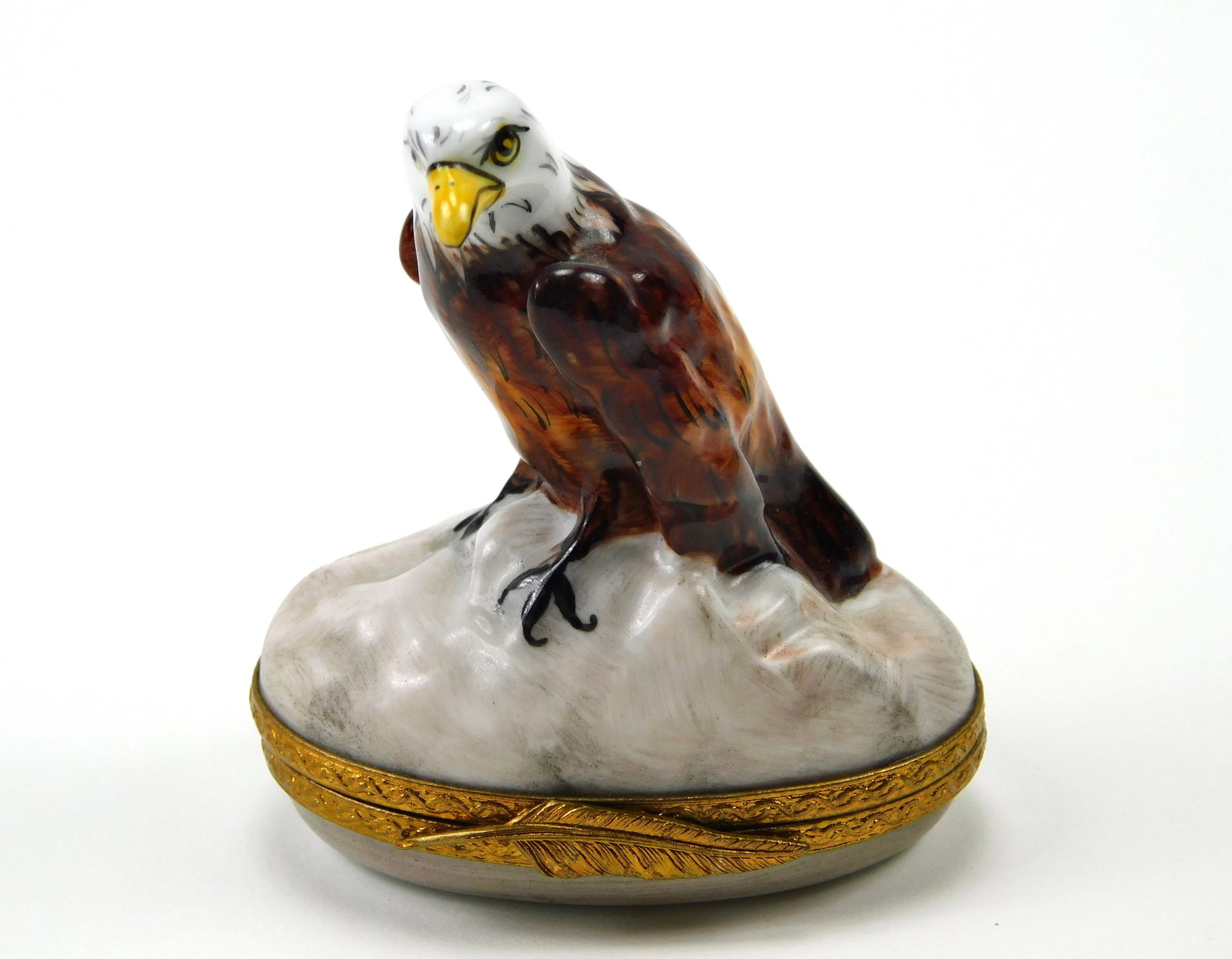 Art de Limoges Pierre Bald Eagle Mountain Porcelain Trinket Box: In House Shipping. Art de Limoges Pierre hand-painted porcelain trinket box featuring a dimensional bald eagle perched on a rocky, snow-detailed mountain. The eagle is decorated with brown and caramel