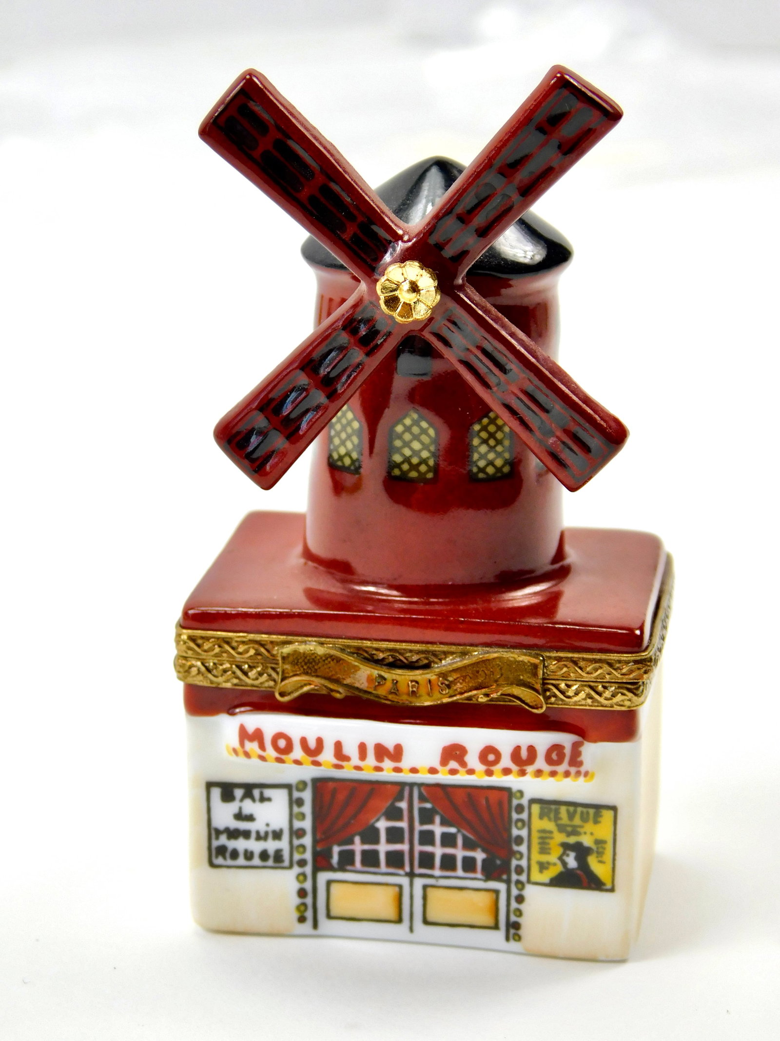 Limoges France Moulin Rouge Paris Porcelain Trinket Box Limited Edition: In House Shipping. Limoges France hand-painted porcelain trinket box modeled as the Moulin Rouge in Paris. The dimensional design features the famous red windmill with lattice-style sails, burgundy-re