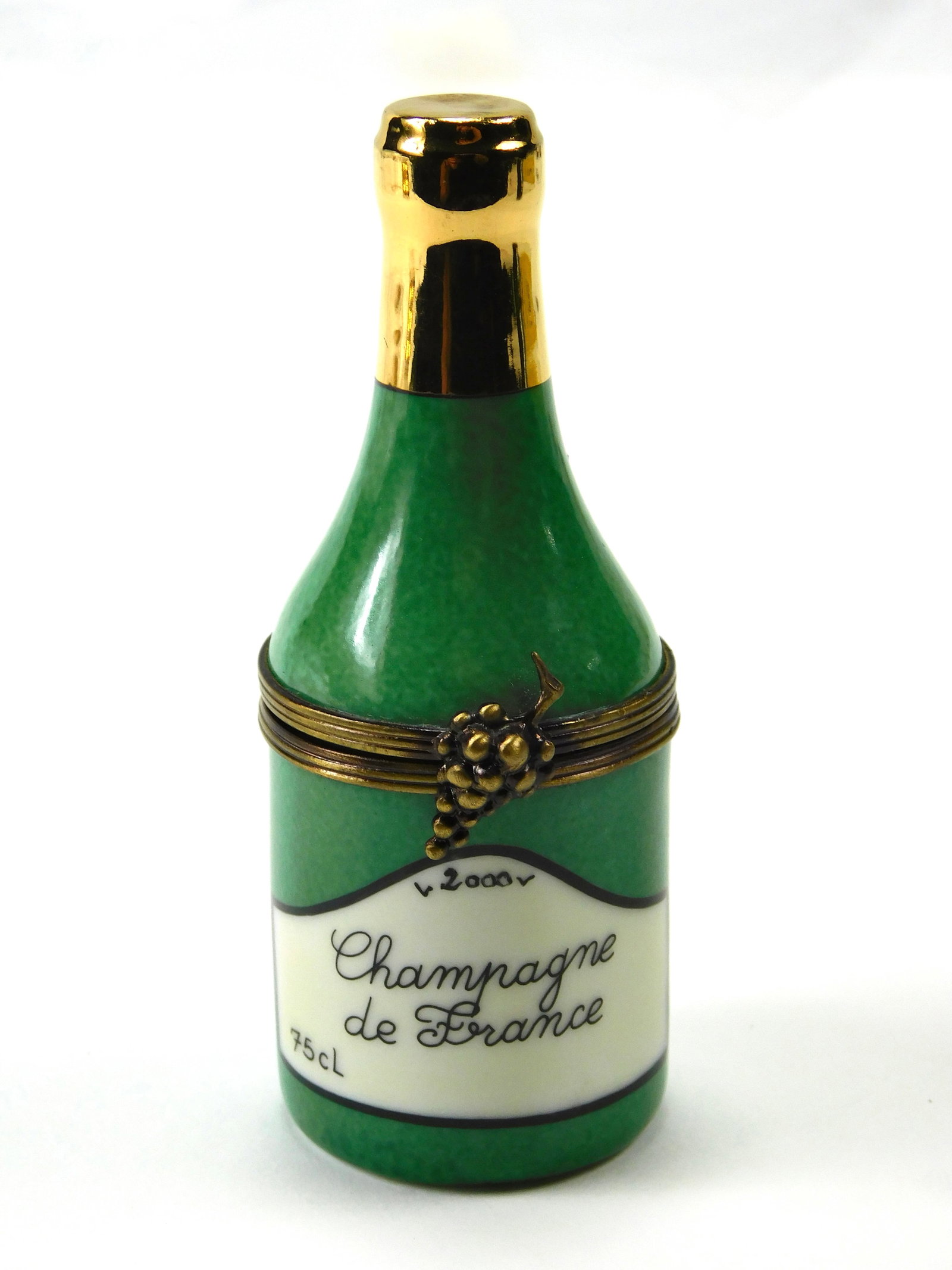 Limoges France Millennium 2000 Champagne Bottle Porcelain Trinket Box: In House Shipping. Limoges France hand-painted porcelain trinket box modeled as a green champagne bottle commemorating the year 2000. The bottle features a mottled green finish, metallic gold-tone nec