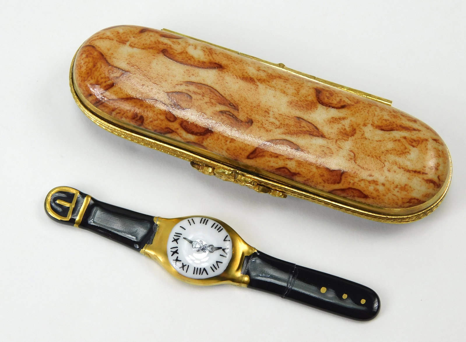 Limoges France Watch Case Porcelain Trinket Box Miniature Wristwatch: In House Shipping. Limoges France hand-painted porcelain trinket box designed as a wristwatch presentation case. The elongated case features a brown and tan faux-marble pattern on the lid with a gloss