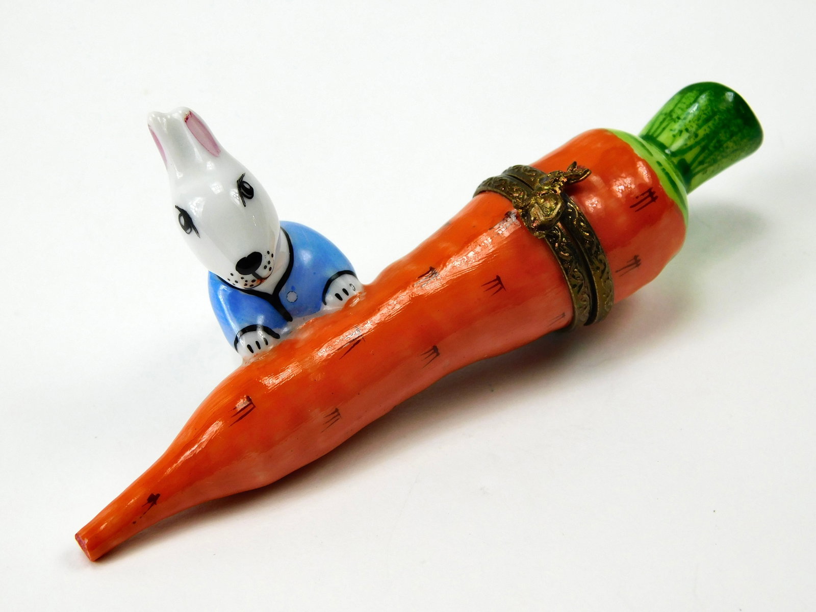 Limoges France Rabbit on Carrot Porcelain Trinket Box Limited Edition 33/1500: In House Shipping. Limoges France hand-painted porcelain trinket box modeled as an orange carrot with green leafy top and a dimensional white rabbit wearing a light blue jacket. Decorative gold-tone m
