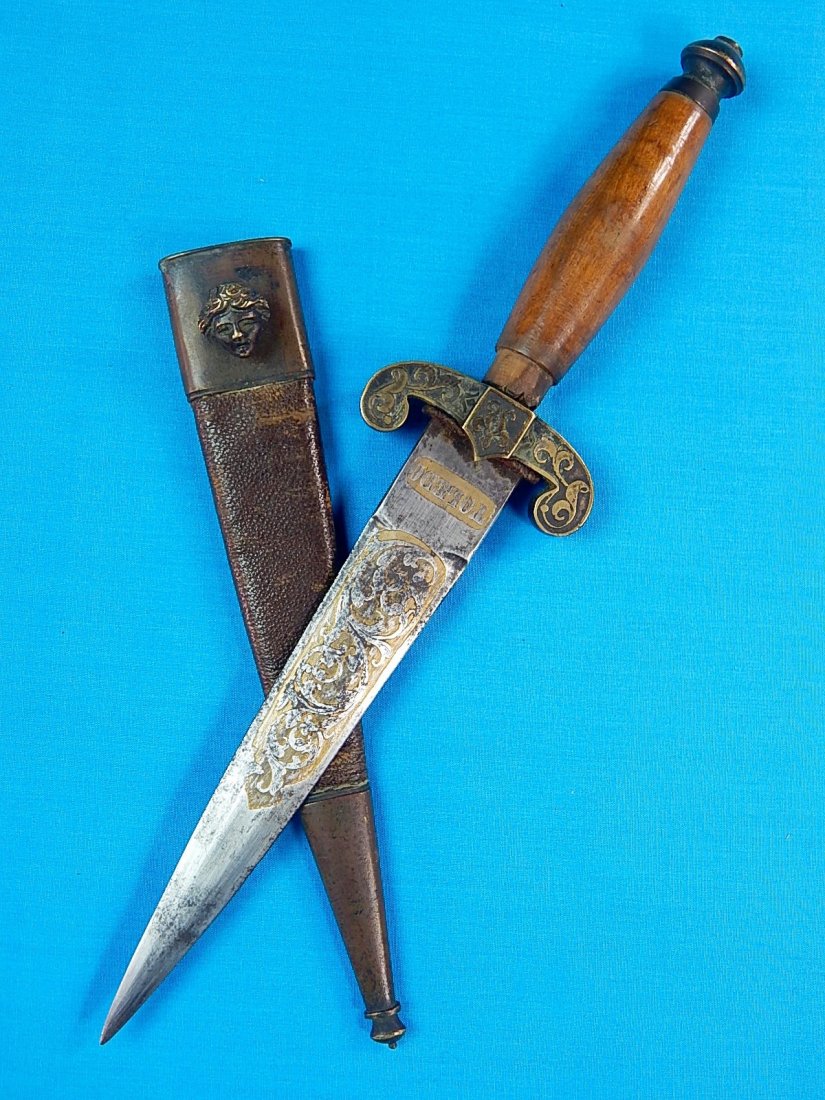 Antique 19 Century Spanish Spain 1867 Dagger Knife: NO BUYER"S PREMIUM! (BUYER"S PREMIUM 0%).Antique 19 Century 1867 Dated Spanish Toledo Engraved Fighting Knife with Leather Scabbard. Size: 10 5/8" long with 6 1/4" blade.We accept payment by check or 
