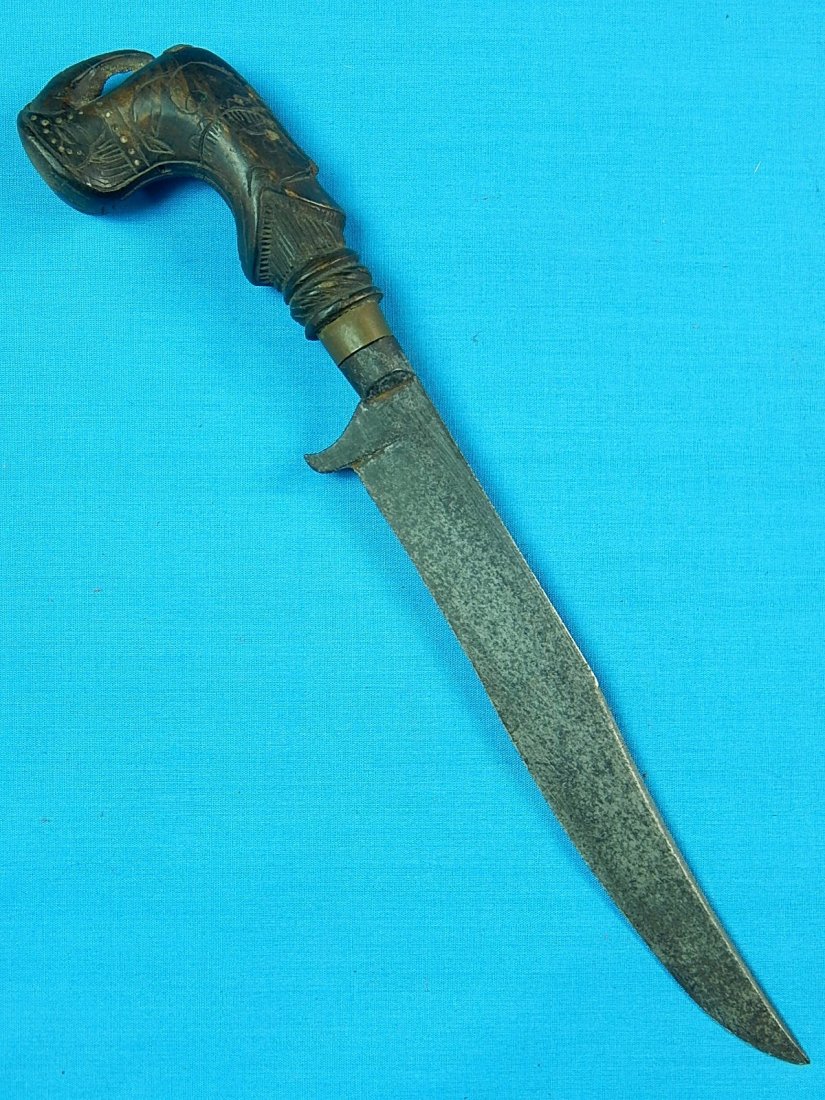 Antique Indonesian Elephant Head Fighting Knife dagger: NO BUYER"S PREMIUM! (BUYER"S PREMIUM 0%).Antique Indonesian Elephant Head Fighting Knife dagger. Carved wood elephant head handle. No sheath. Size: 9 7/8" long with 6 1/4" blade.We accept payment by c
