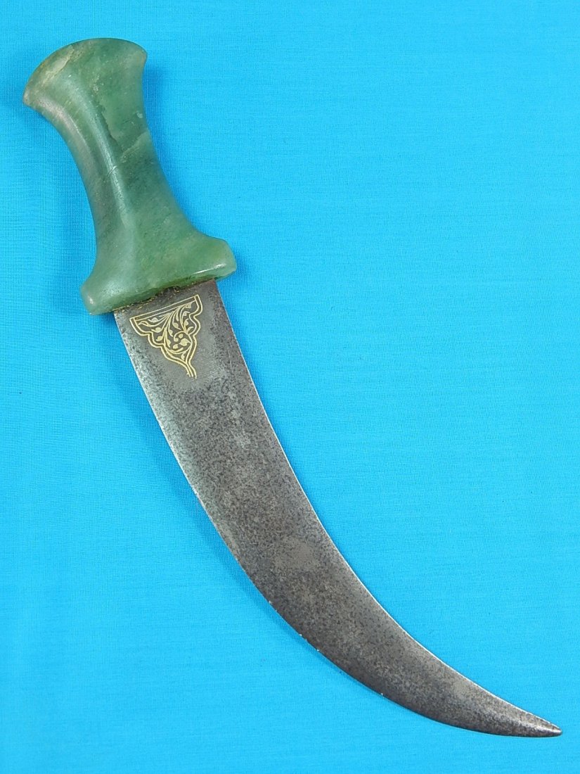 Antique Middle East Jade Wootz Engraved Fighting Knife: NO BUYER"S PREMIUM! (BUYER"S PREMIUM 0%).Antique 19 Century Middle Eastern Fighting Knife. Jade handle. Engraved wootz blade. No sheath. Size: 12 1/8" long with 8" blade.We accept payment by check or
