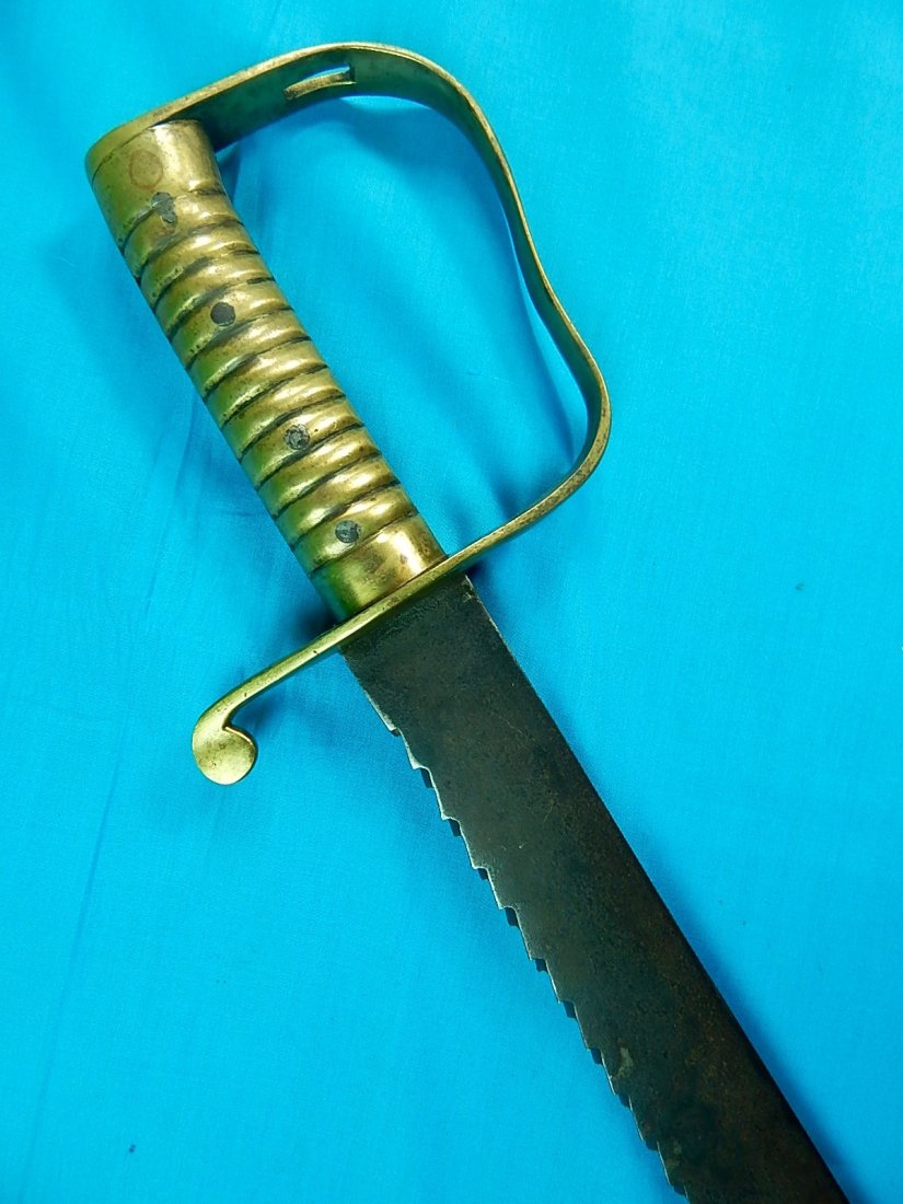 British English Antique 19 C Model 1856 Saw Back Sword: NO BUYER"S PREMIUM! (BUYER"S PREMIUM 0%).British 19 Century Model 1856 Saw Back Sword.No scabbard.The guard is marked. The sword is 27 1/2" long with 22 1/2" blade.We accept payment by check or money