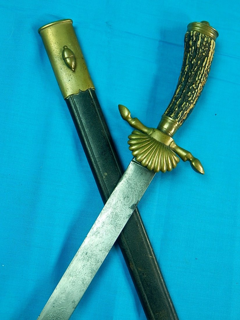 German Germany WW2 Short Stag Hunting Engraved Sword: NO BUYER"S PREMIUM! (BUYER"S PREMIUM 0%).Original German WW2 Short Hunting Engraved Sword with Scabbard. Stag handle.22 1/2" total length. The blade is 17 1/8".We accept payment by check or money orde