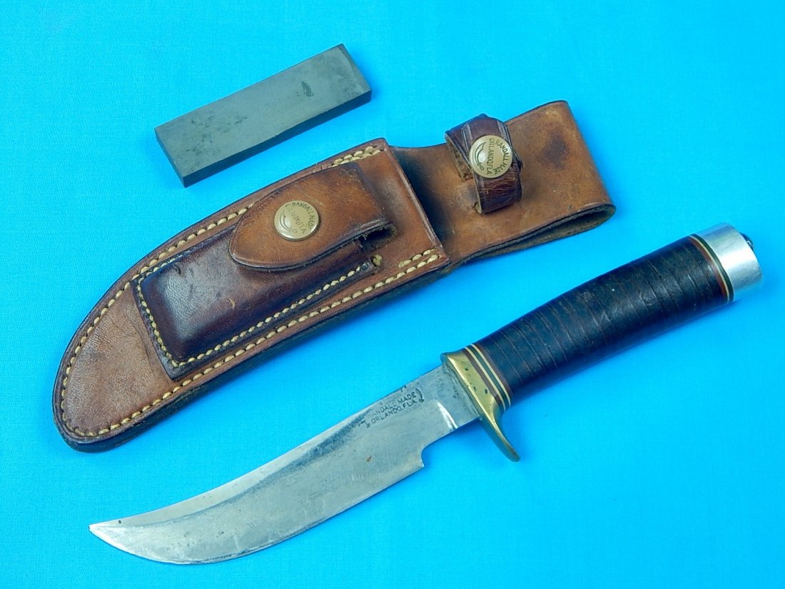 Vintage 1960's US Custom Made RANDALL 4 5 Hunting Knife: NO BUYER"S PREMIUM! (BUYER"S PREMIUM 0%).Vintage 1960's US Custom Made RANDALL 4 5 Hunting Knife with Leather Sheath and Sharpening Stone. Size: 9 7/8" long with 5 1/4" blade.We accept payment by chec