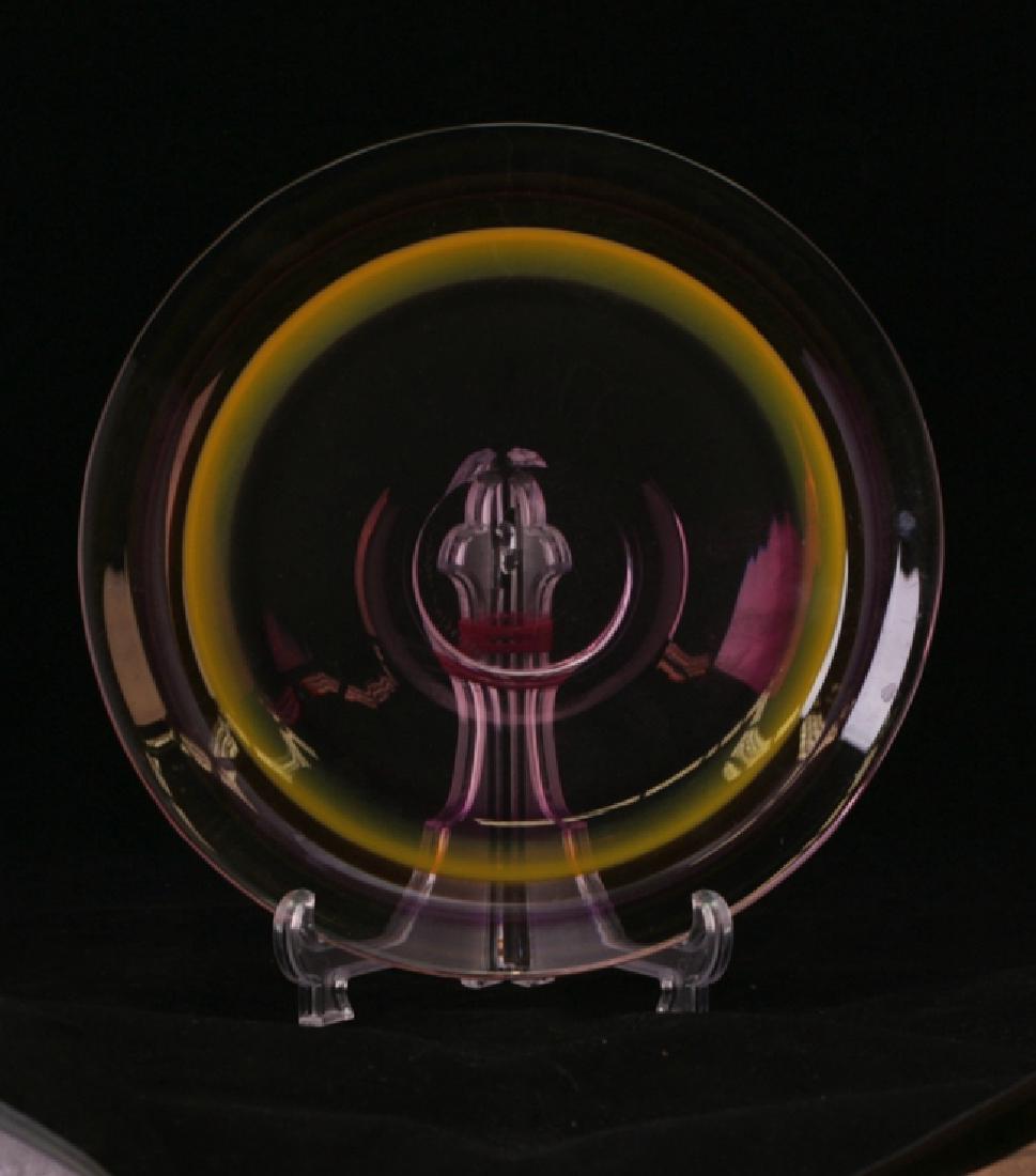A multi-colored shallow glass bowl: Purple and yellow ring design. 23cm diameter