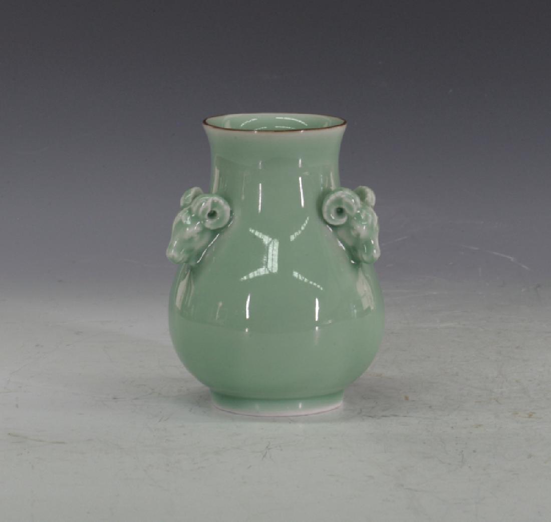 Longquan Vase: Double musk goat handles. With a dark brown edged rim. 15cm height.