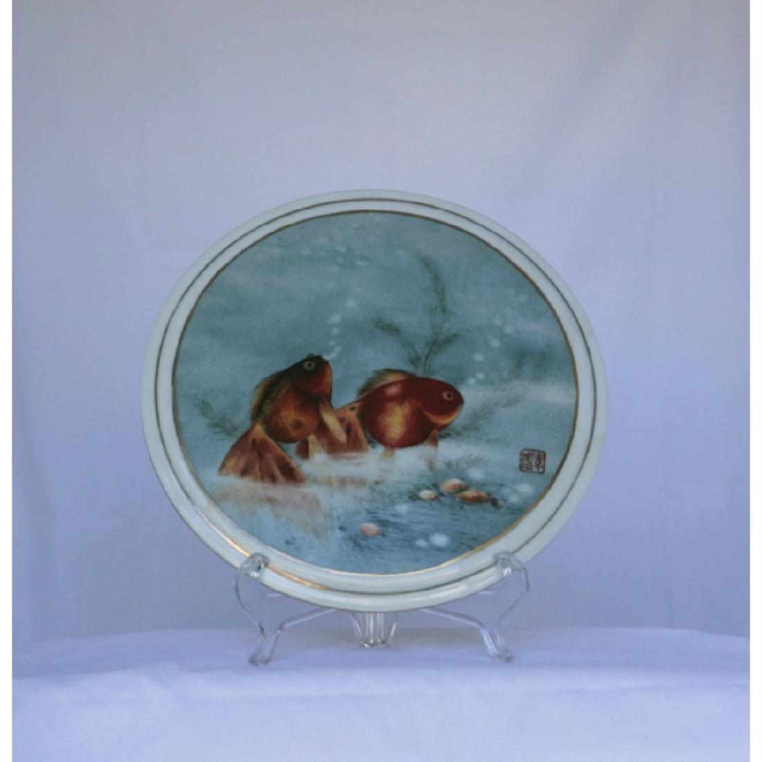 An Impressively Painted Presentation Tile: Goldfish swimming in turquoise background. 25cm diameter.