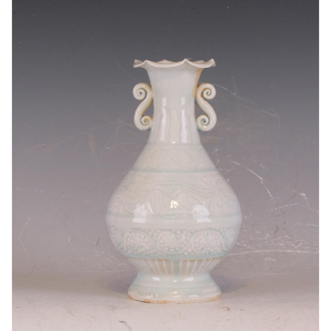 A Ding Ware Vase: It has a double handle and weaved lotus pattern on the top realm. Height 19.5 cm