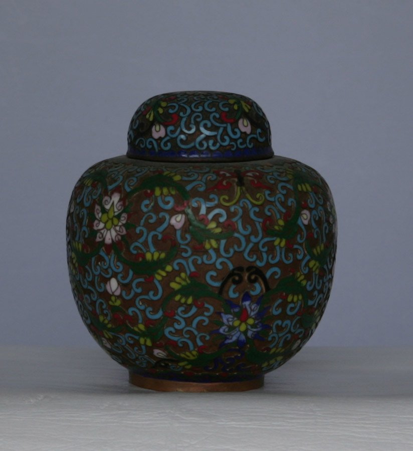 Small cloisonné covered ginger jar: Intricate stylised decoration all over. 14cm high; 13cm wide.