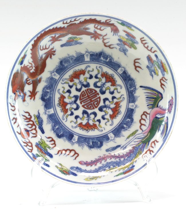 Chinese Famille Rose Dish: Decorated with a phoenix and a dragon in multiple colors. The center of the dish - a Shou symbol, surrounded by five bats. Yong Zheng mark on the base. 20cm diameter.