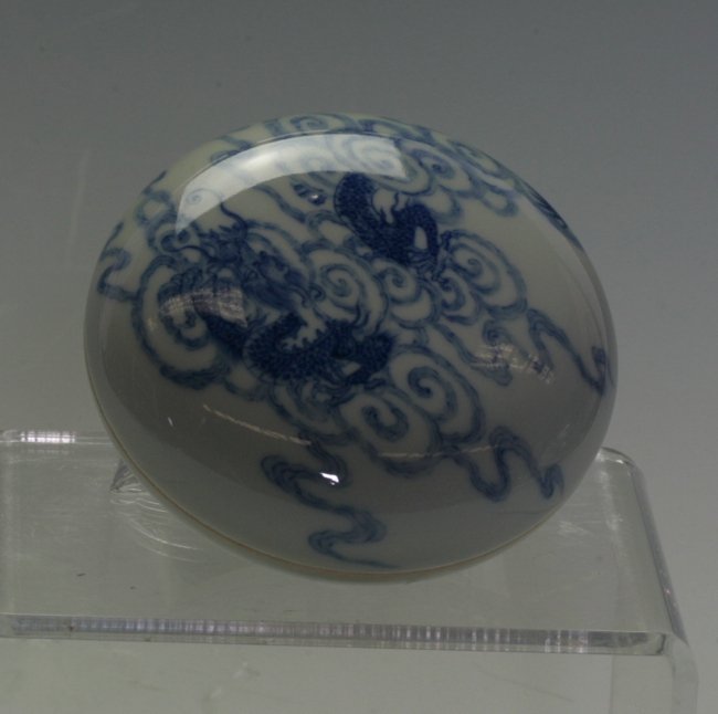 Blue and White Stamp Box: Painted in bright blue - a dragon flying over the clouds. Six Kang Xi mark on the base. 8.5cm diameter.