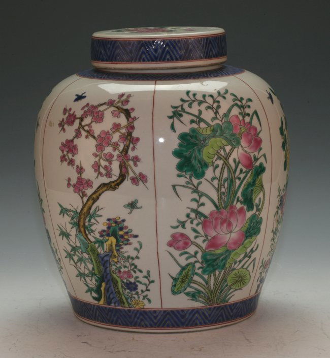 Famille Rose Covered Ginger Jar: Presented with panels of flowers from different seasons all around in multi-color. Kang Xi mark on the base. 28.5cm height.