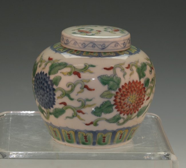Doucai Covered Jar: Green, red and blue over and under glazing. 8.5cm height. Ming dynasty.
