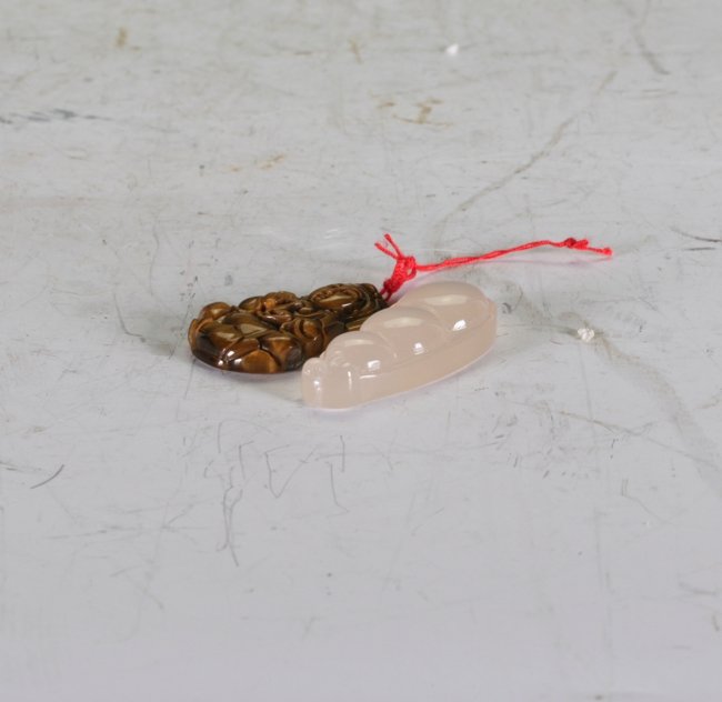 Cat's Eye and White Jade: Two pendants.