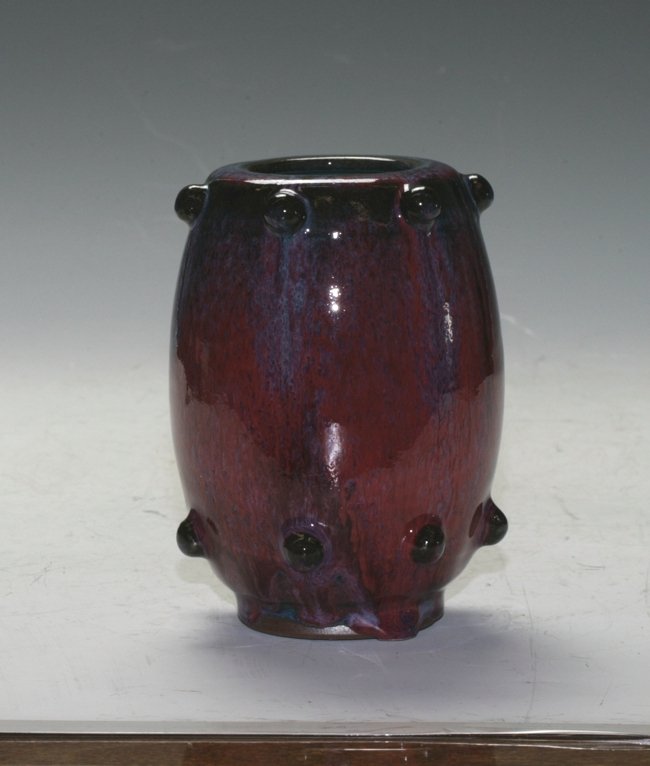 Chinese Flambe Vase: With nail stud decorations on the top and bottom. Red sky and ox hair glazing. 15cm height.