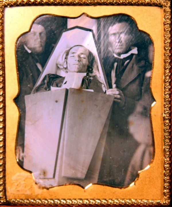 Man in Casket Daguerreotype: 32. Man in Casket Daguerreotype, 1/6 plate, Naylor Collection notes: "Episcopal minister in folding top casket placed at 45 degree angle with men standing on both sides", leather case, resealed. Prove