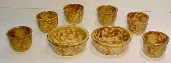 Bennington Yelloware Items: Group of eight Bennington style yellow ware items, bowls ht. 5, cups ht. 3, wd. 2 ½