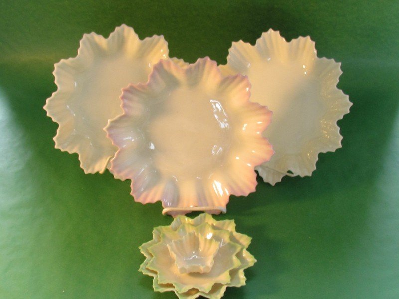 Lot of five leaf form plates and an open salt: Lot of five leaf form plates and an open salt: Three large, two butter, and one salt. Five pieces are second are second mark, black. One large plate is unmarked, small chips on several pieces, larger