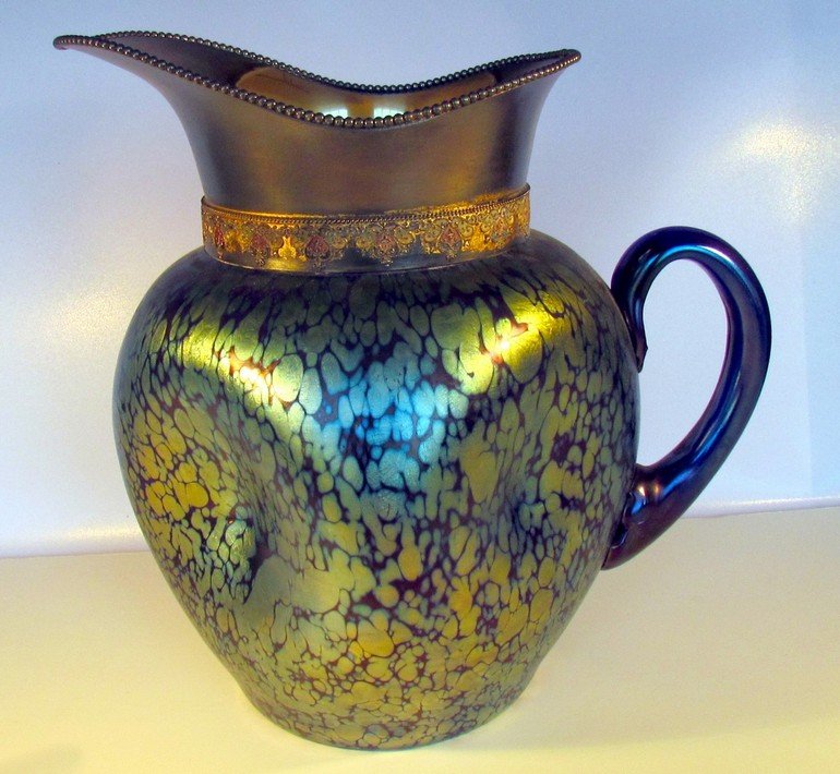 Large Austrian Art Glass Pitcher: Large Austrian Art Glass Pitcher in the style of Loetz, silverplate mount, height 9 3/4, width 10 inches.