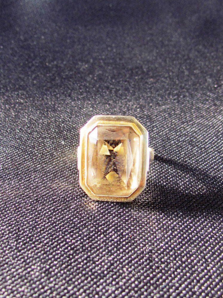 Large 14K Topaz Ring.: 14K yellow gold emerald cut 13mm X 10mm topaz ring. Art deco style bezel set and double framed. Ring measures two in. lg. from side. Weight 6.2g.